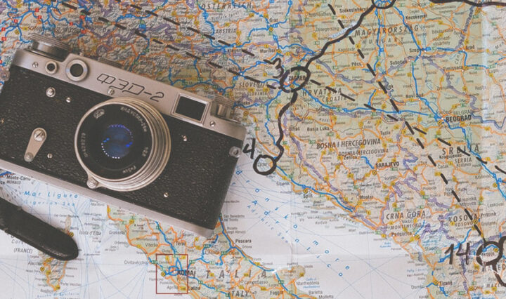 saving money - cash and passport on a map