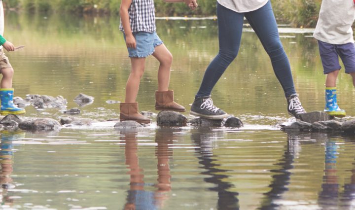 free UK family days out - family crossing stepping stones across river