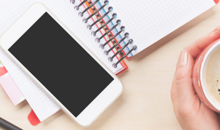 how to make your screen brighter - smartphone sat on top of a diary