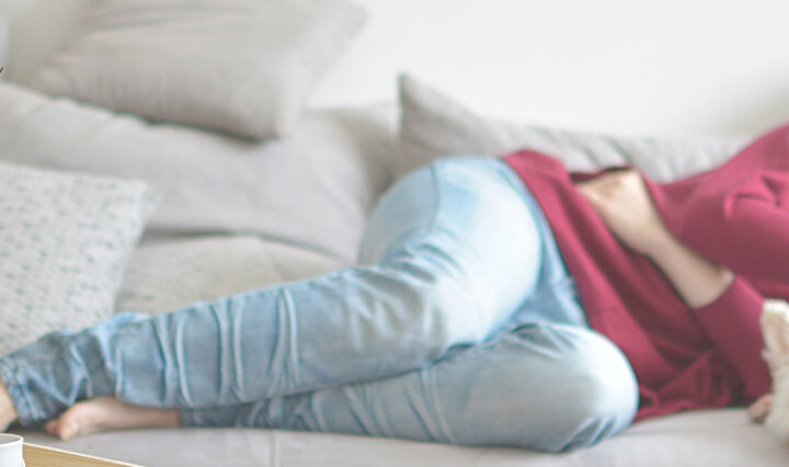 woman asleep on sofa with dog