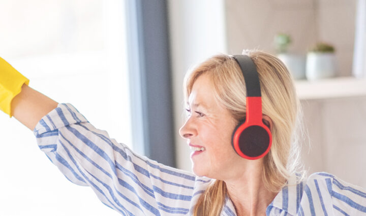 woman wearing headphones listening to my housework Spotify playlist