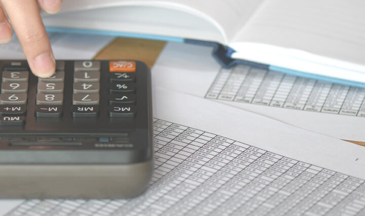 calculator and papers on desk, hand using calculator to work out finances after finding ways to save money when working from home to buy new kitchen appliances, is the bank the best place to borrow money from. Business and finance are fast-paced and ever-changing.