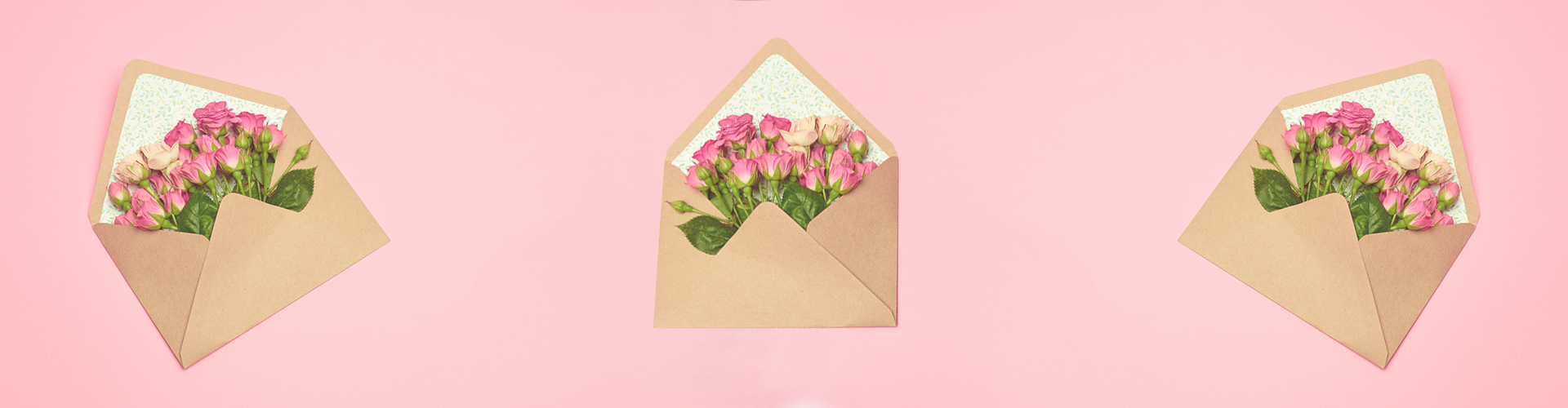 roses tucked inside an envelope with pink background