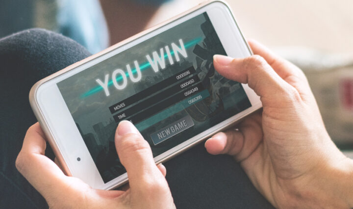 woman playing games online on her phone