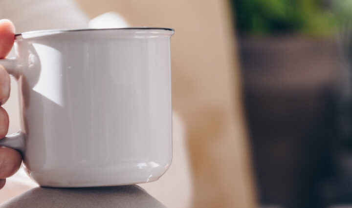elderly hand holding mug