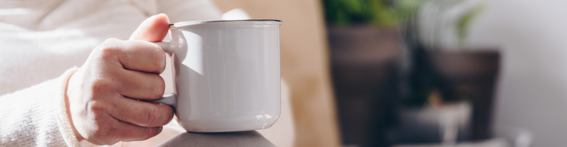 elderly hand holding mug